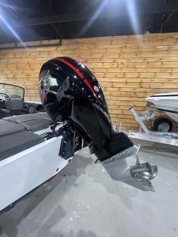 Slide: The Image of 2024 Lund Crossover XS 1875 boat with a powerful outboard motor. - 7