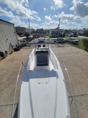 Slide: The Image of 1998 Donzi 35 ZF boat on a trailer in a parking lot under a cloudy sky. - 11