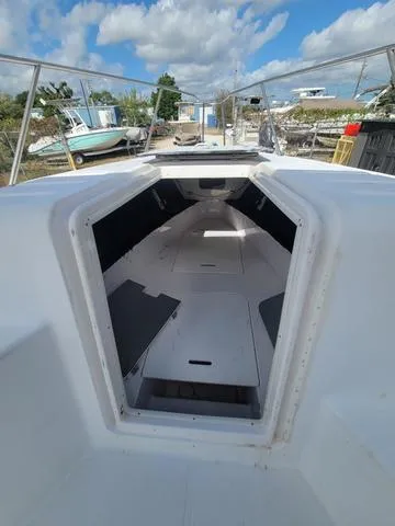 Slide: The Image of 1998 Donzi 35 ZF boat interior with open cabin under a partly cloudy sky. - 12