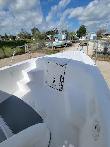 Slide: The Image of 1998 Donzi 35 ZF boat deck with seating, under a partly cloudy sky. - 13