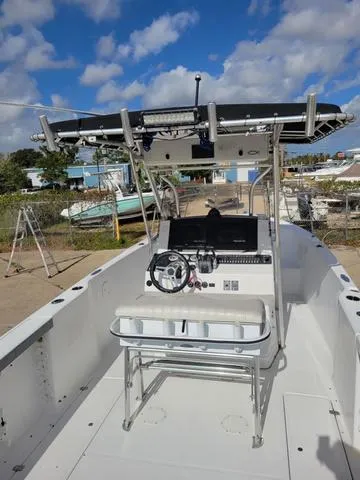 Slide: The Image of 1998 Donzi 35 ZF boat with open deck and steering console under a blue sky. - 14