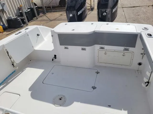 Slide: The Image of 1998 Donzi 35 ZF boat interior with storage compartments and Mercury engines. - 15