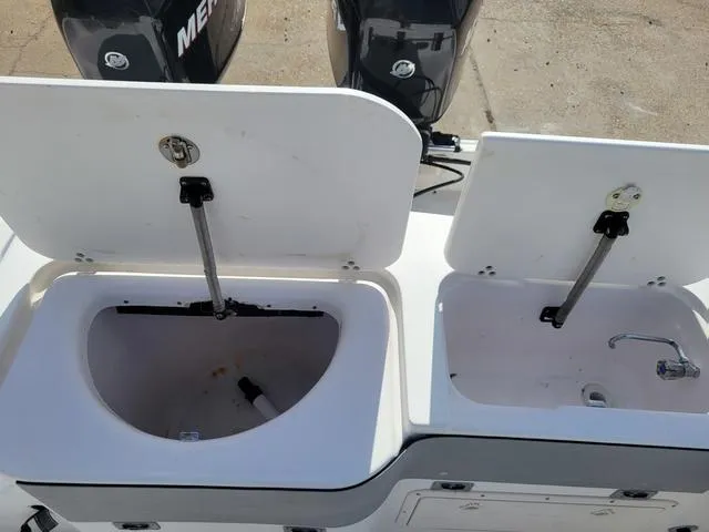 Slide: The Image of 1998 Donzi 35 ZF boat with open storage compartments and dual Mercury engines. - 17