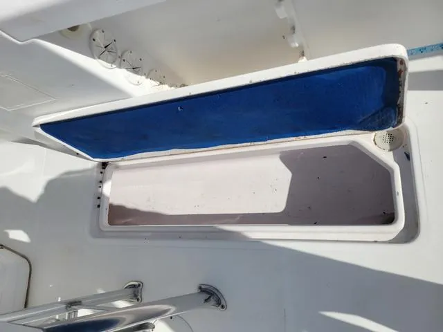 Slide: The Image of Open storage compartment on a 1998 Donzi 35 ZF boat, featuring a blue interior lid. - 18