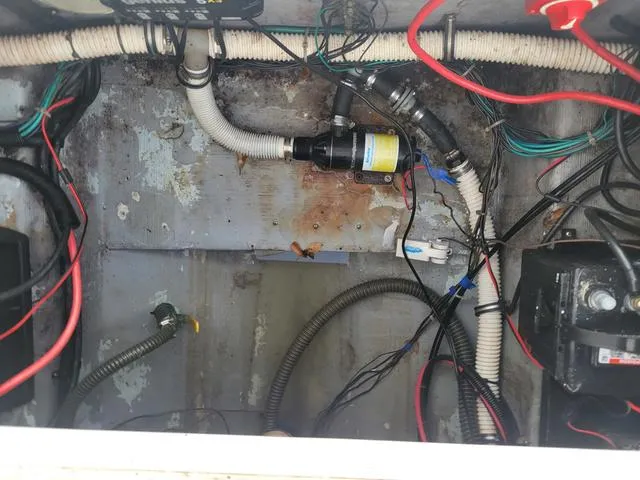 Slide: The Image of 1998 Donzi 35 ZF boat wiring and plumbing components in engine compartment. - 20