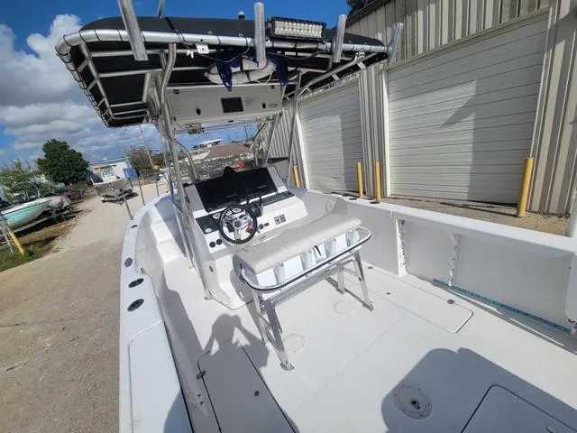 Slide: The Image of 1998 Donzi 35 ZF boat with center console and T-top, parked outdoors. - 9
