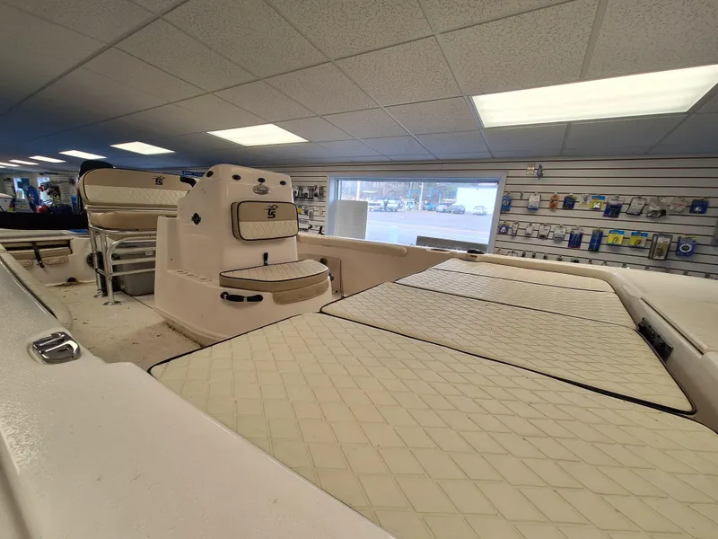 Slide: The Image of 2023 Carolina Skiff 19 LS boat interior with cushioned seating and storage compartments. - 10