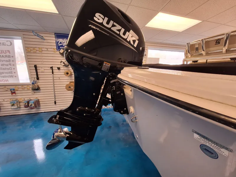 Slide: The Image of 2023 Carolina Skiff 19 LS with Suzuki outboard motor in showroom. - 12