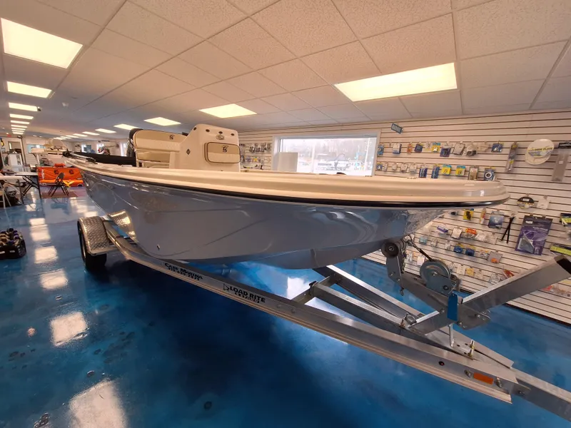 Slide: The Image of 2023 Carolina Skiff 19 LS boat on a trailer in a showroom. - 2