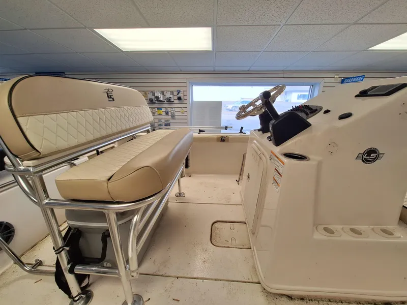 Slide: The Image of 2023 Carolina Skiff 19 LS boat interior with beige seating and steering console. - 8