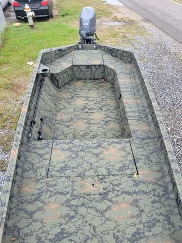Slide: The Image of 2024 Edge Duck Boats 653DB camo-patterned interior with outboard motor. - 10