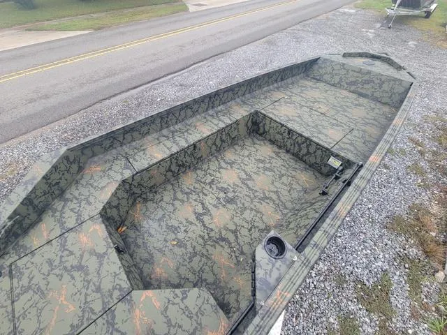 Slide: The Image of 2024 Edge Duck Boats 653DB camo-patterned interior on gravel lot. - 6