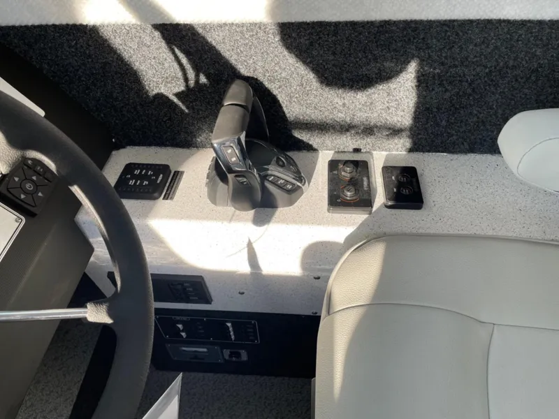 Slide: The Image of 2024 KingFisher 2725 Weekender boat interior controls and steering wheel. - 11