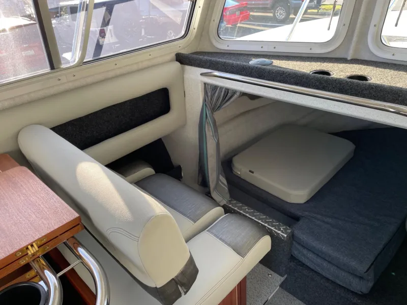 Slide: The Image of 2024 KingFisher 2725 Weekender boat interior with seating and cabin area. - 12