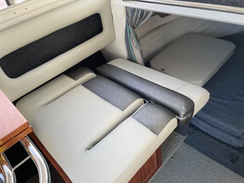 Slide: The Image of 2024 KingFisher 2725 Weekender interior seating and sleeping area, featuring modern upholstery. - 13
