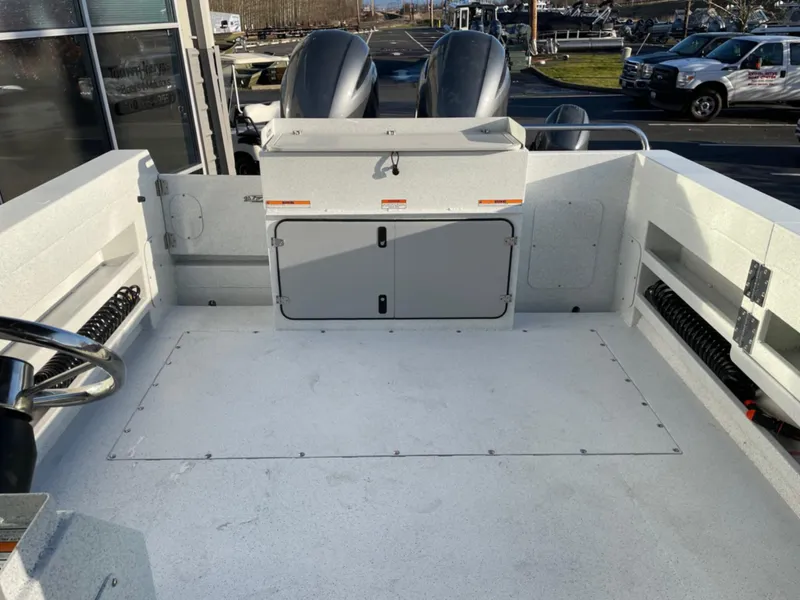 Slide: The Image of 2024 KingFisher 2725 Weekender boat interior with dual engines and storage compartment. - 6