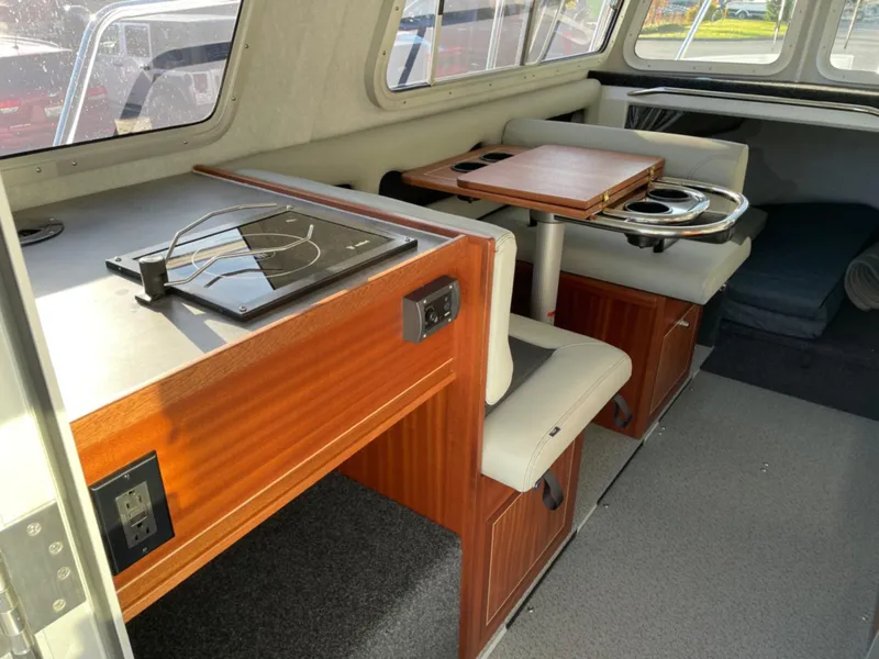 Slide: The Image of Interior of 2024 KingFisher 2725 Weekender boat with seating and table setup. - 8