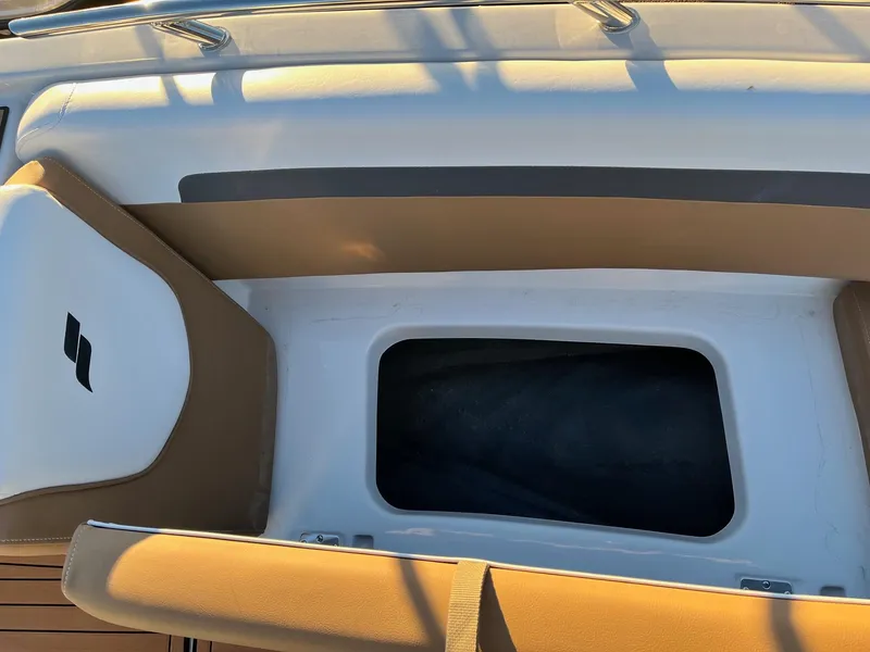 Slide: The Image of 2024 Starcraft SVX 191 boat interior storage compartment with cushioned seating. - 19