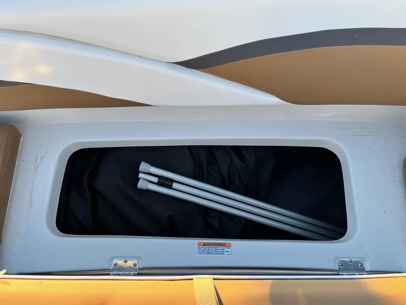 Slide: The Image of Storage compartment of 2024 Starcraft SVX 191 boat with poles inside. - 11