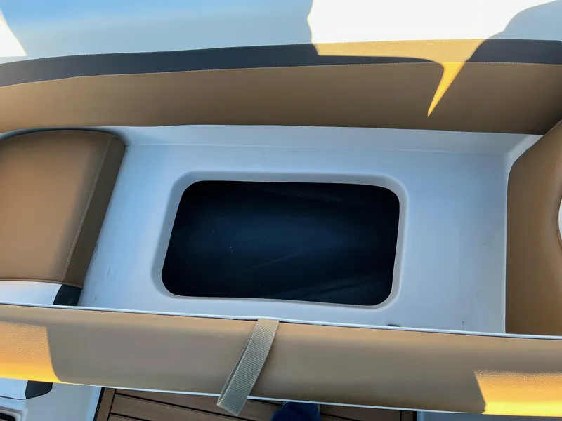 Slide: The Image of 2024 Starcraft SVX 191 boat storage compartment with tan seating. - 16