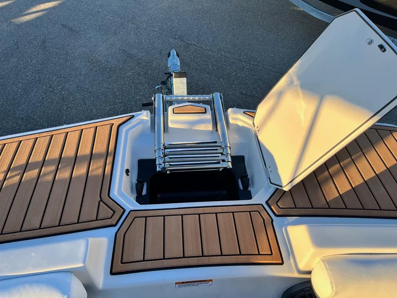 Slide: The Image of 2024 Starcraft SVX 191 boat with open storage compartment and ladder. - 20