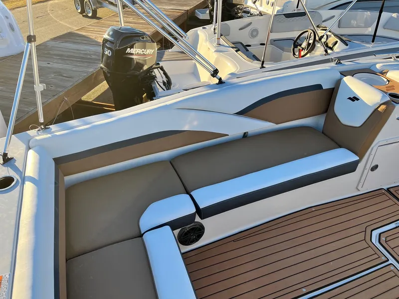 Slide: The Image of 2024 Starcraft SVX 191 boat interior with cushioned seating and Mercury outboard motor. - 5