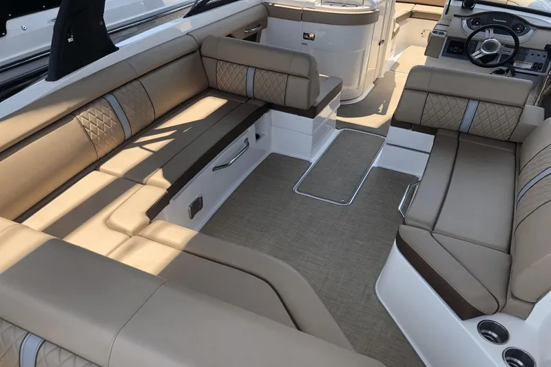 Slide: The Image of 2017 Sea Ray SDX 270 boat interior with luxurious tan seating and modern design. - 14