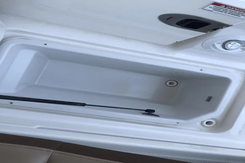 Slide: The Image of Storage compartment of a 2017 Sea Ray SDX 270 boat, featuring a white interior. - 32