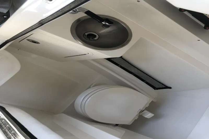 Slide: The Image of Interior of 2017 Sea Ray SDX 270 boat bathroom with sink and toilet. - 33