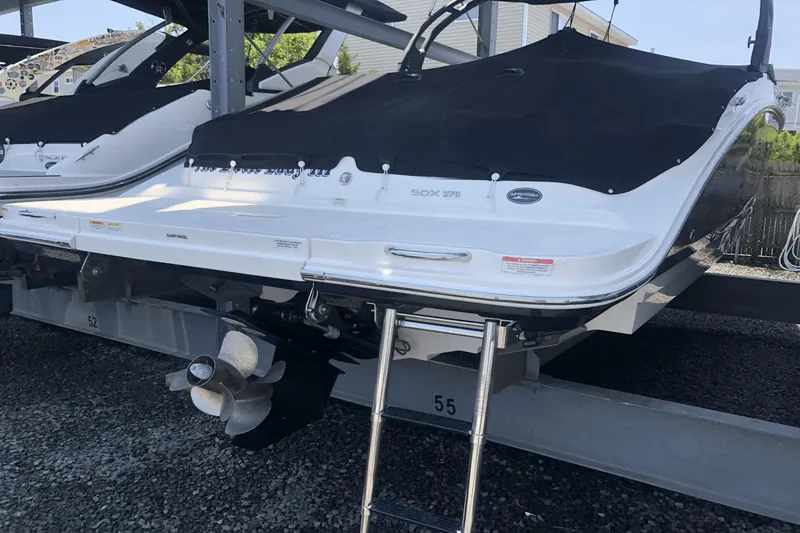Slide: The Image of 2017 Sea Ray SDX 270 boat with black cover on a lift. - 9