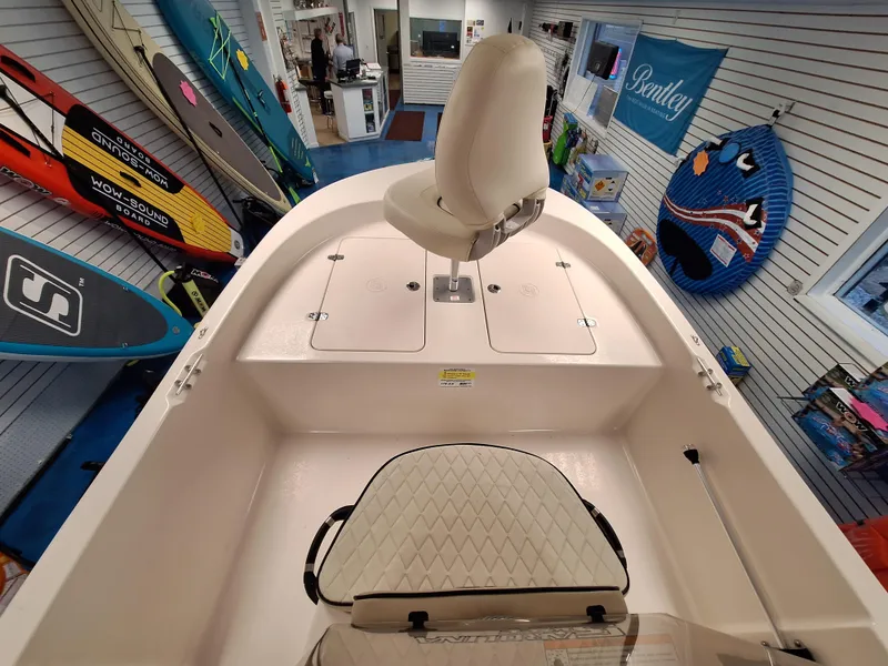 Slide: The Image of 2023 Carolina Skiff 178 JLS boat interior with seating and storage compartments. - 6