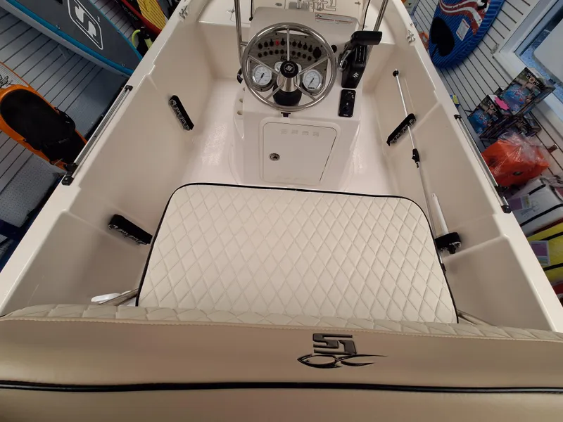 Slide: The Image of 2023 Carolina Skiff 178 JLS boat interior with steering console and cushioned seating. - 7