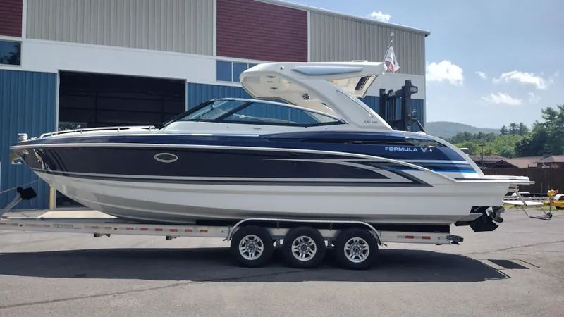 The Image of 2026 Formula 330 CBR boat on trailer outside a warehouse. - 0