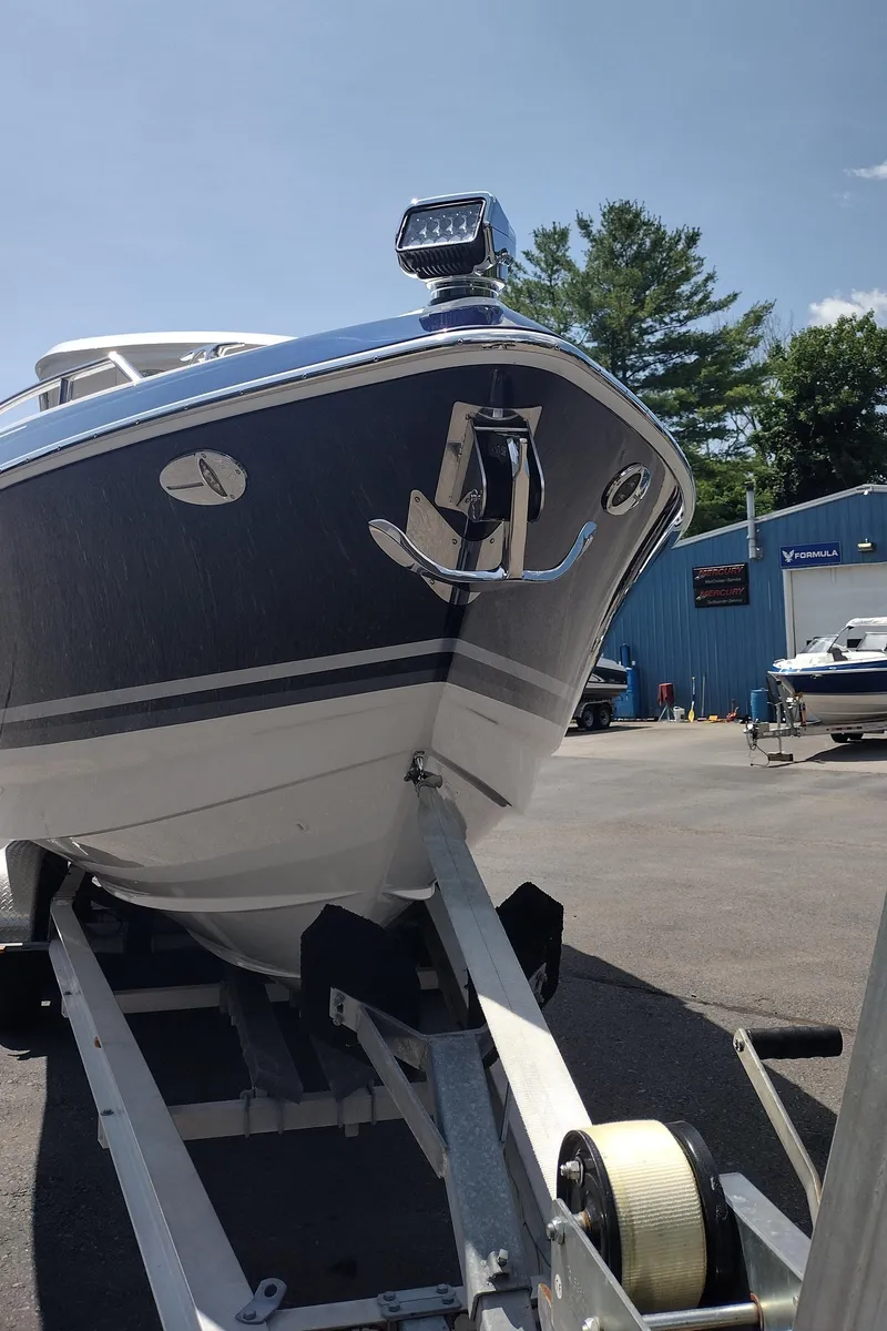 Slide: The Image of 2026 Formula 330 CBR boat on trailer, parked outdoors under clear sky. - 2