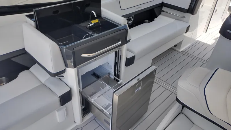 Slide: The Image of 2026 Formula 330 CBR boat interior with open fridge and sleek seating. - 26