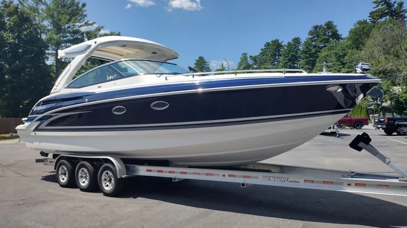 Slide: The Image of 2026 Formula 330 CBR boat on trailer, parked outdoors under clear sky. - 3