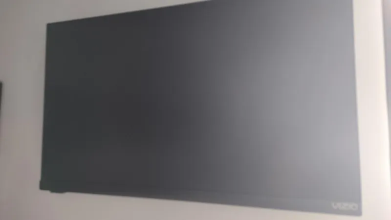 Slide: The Image of A Vizio flat-screen TV mounted on a white wall. - 37