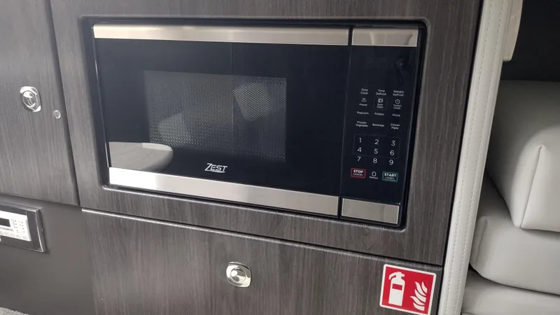 Slide: The Image of Built-in microwave in 2026 Formula 330 CBR boat interior. - 39