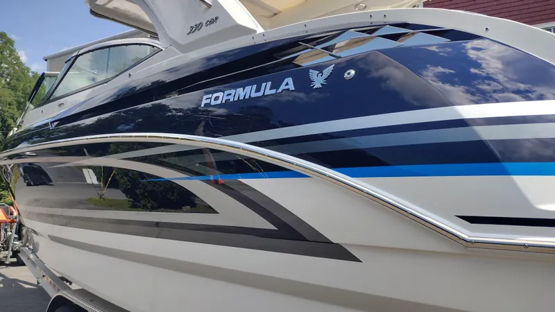 Slide: The Image of 2026 Formula 330 CBR boat with sleek design and reflective finish. - 7