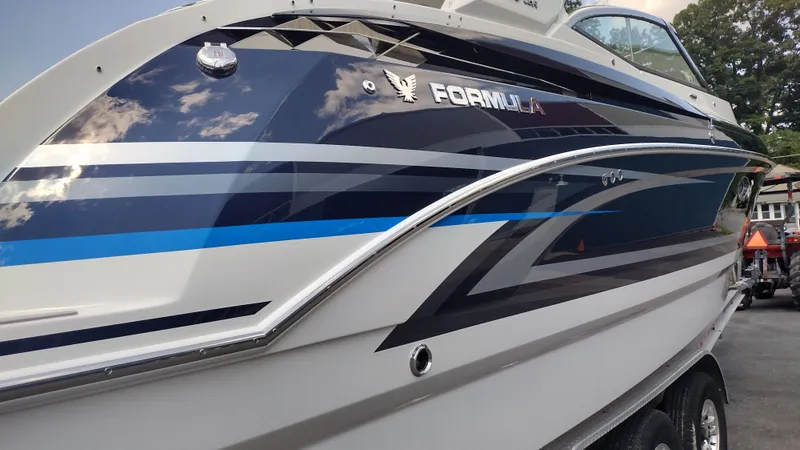 Slide: The Image of 2026 Formula 330 CBR boat with sleek blue and white design on trailer. - 8