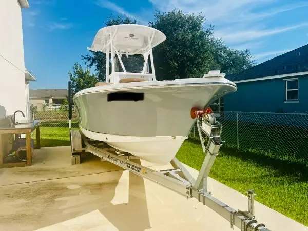 The Image of 2021 Sea Hunt 234 Ultra boat on trailer in driveway. - 1