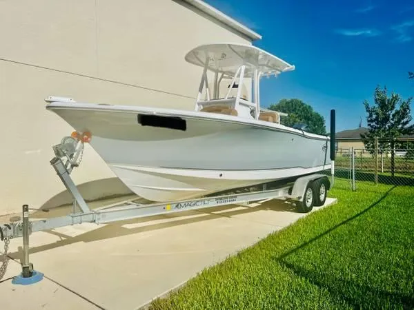Slide: The Image of 2021 Sea Hunt 234 Ultra boat on a trailer in a sunny yard. - 2