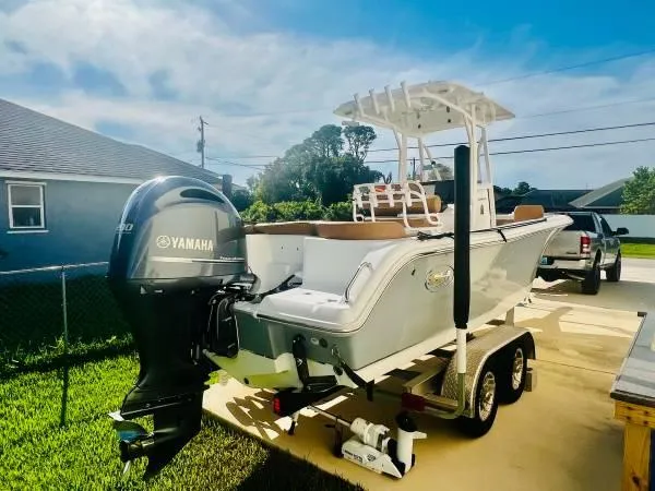 Slide: The Image of 2021 Sea Hunt 234 Ultra boat with Yamaha engine on trailer in driveway. - 4