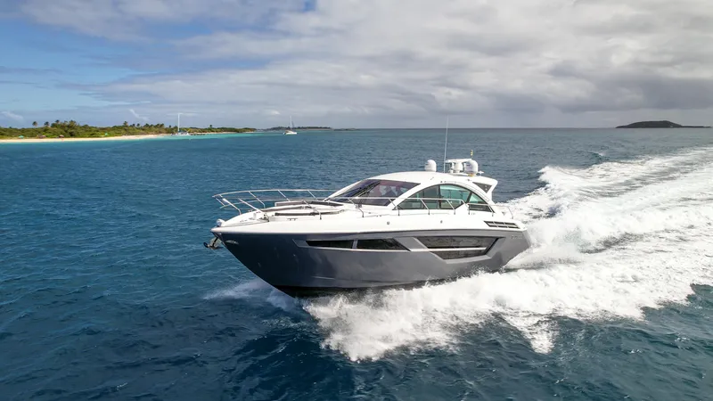 Slide: The Image of 2019 Cruisers Yachts 50 Cantius cruising on open water near a tropical island. - 12