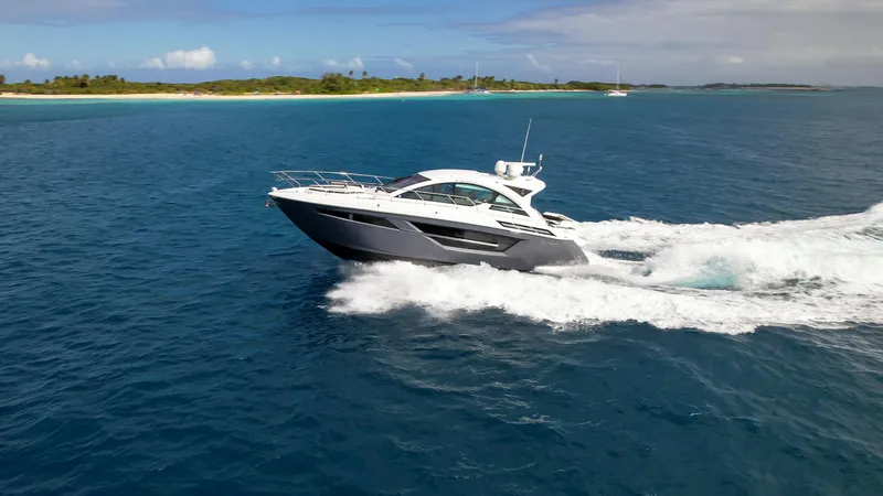 Slide: The Image of 2019 Cruisers Yachts 50 Cantius cruising on open water near a tropical island. - 18