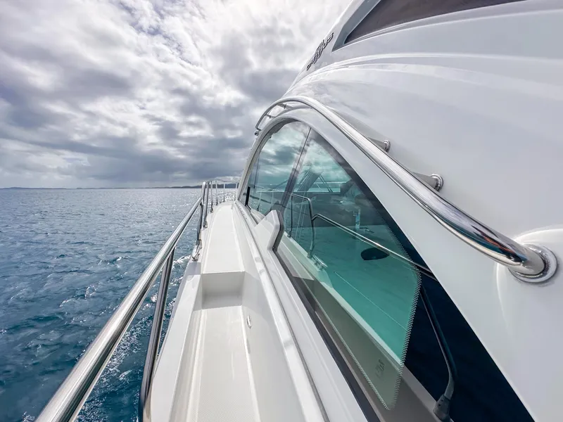 Slide: The Image of 2019 Cruisers Yachts 50 Cantius on open water under cloudy sky. - 23
