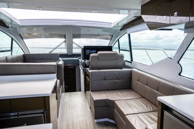 Slide: The Image of Interior of 2019 Cruisers Yachts 50 Cantius with modern seating and panoramic windows. - 31