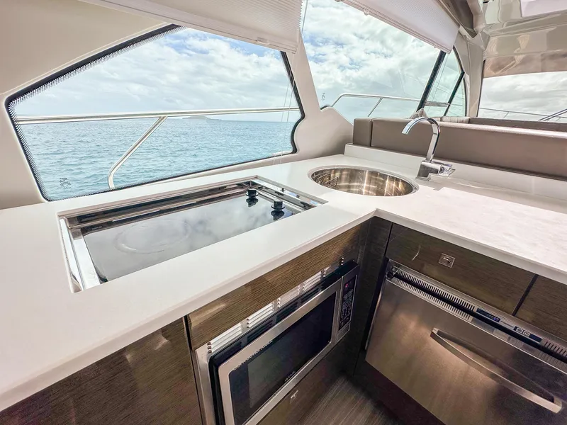 Slide: The Image of Modern kitchen area on 2019 Cruisers Yachts 50 Cantius with ocean view. - 34