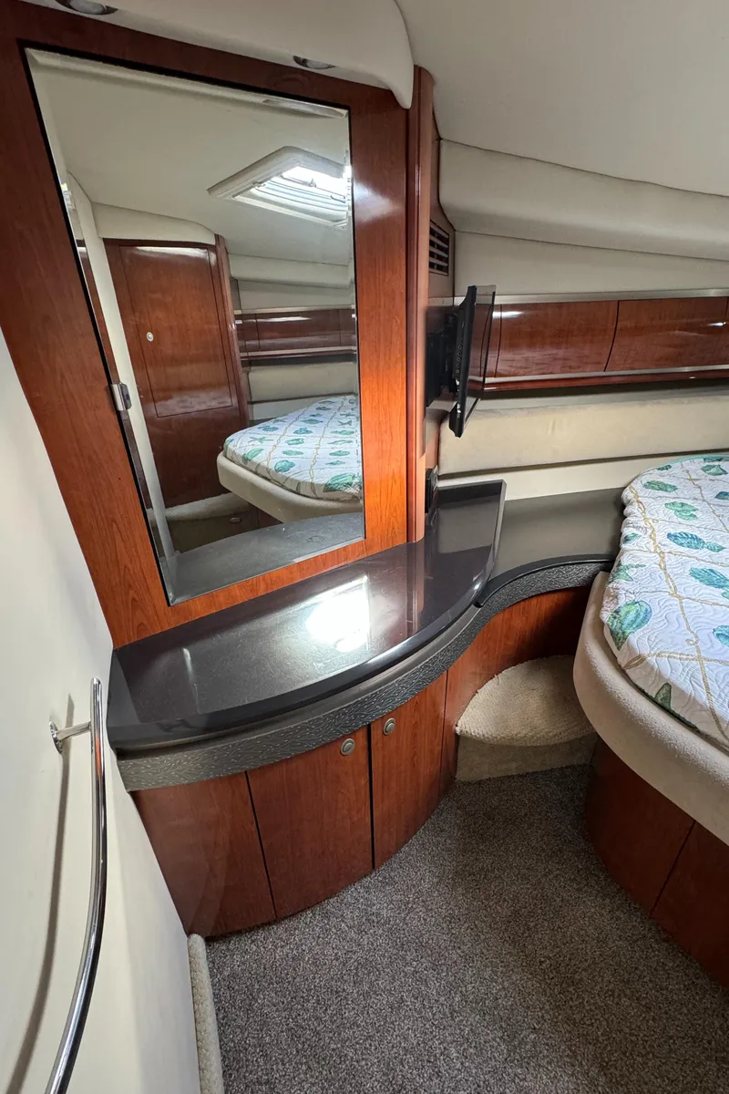 Slide: The Image of 2004 Sea Ray 500 Sundancer cabin interior with vanity and bed. - 13