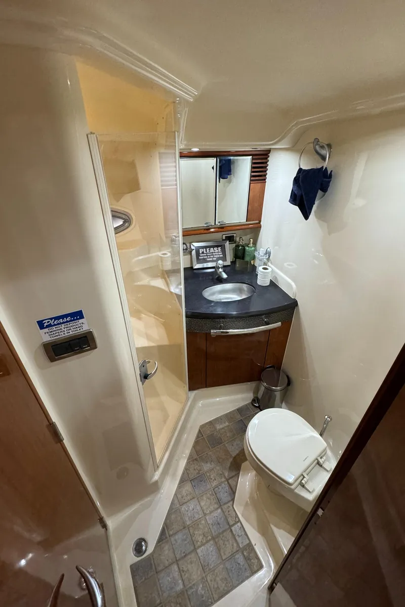 Slide: The Image of 2004 Sea Ray 500 Sundancer bathroom with shower, sink, and toilet. - 14